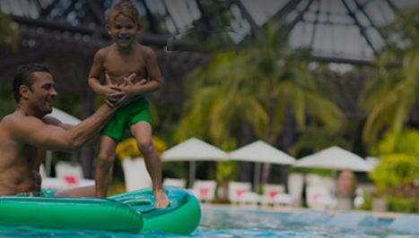 parent and child playing in pool