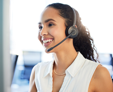woman smiling on the phone working at call center as travel concierge