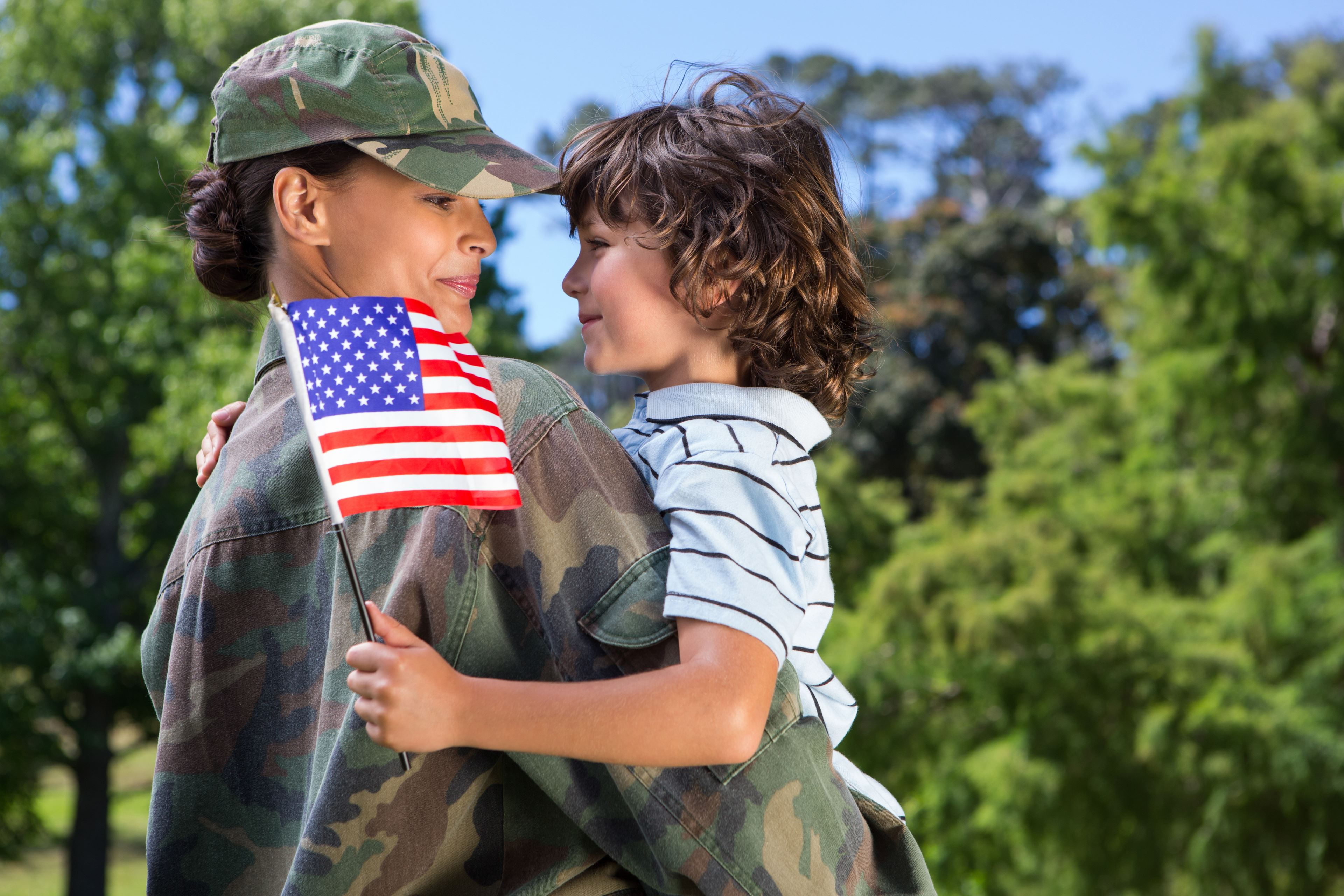 woman veteran holding child